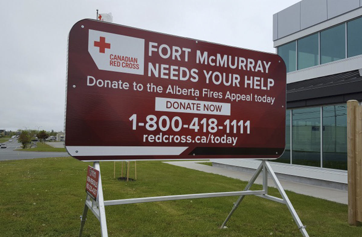 POSTCARD PORTABLES PROVIDES SIGNS FOR RED CROSS TO HELP FORT MCMURRAY
